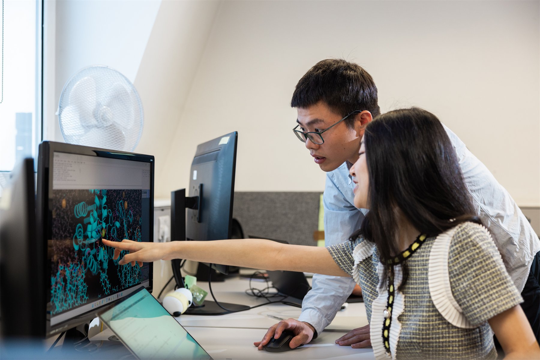 Researchers examining a molecular simulation